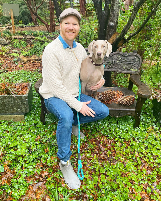 Joe Abken with dog on garden bench