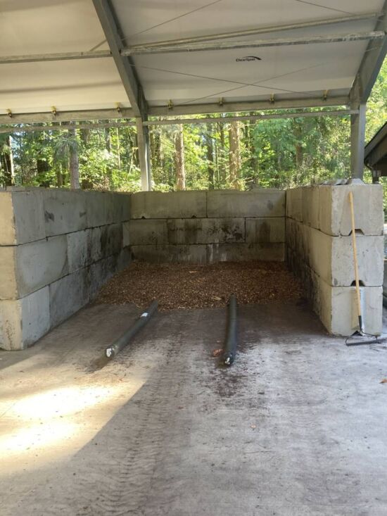 When constructing our Aerated Static Piles (ASP) we first lay down a layer of chips over the pipes in the bottom of the bin. This is called a “air plenum layer” and it helps ensure uniform air distribution from below the pile. Plenum Layer Below Compost Batch